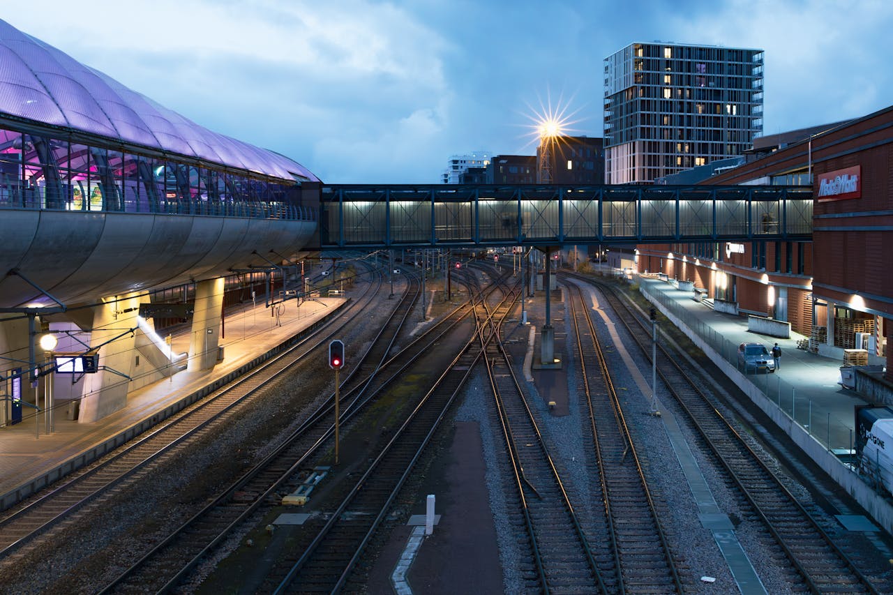 A train station with a large building in the background